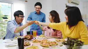 happy-young-friends-group-having-lunch-home-asia-family-party-eating-pizza-food-laughing-enjoying-meal-while-sitting-dining-table-together-house-celebration-holiday-togetherness